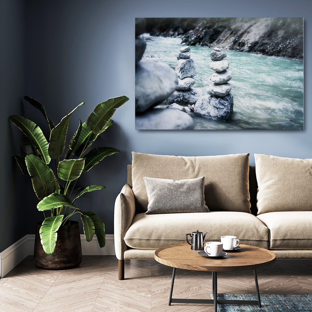 River Cairn Nature Photography – above a sofa on a navy wall with plant