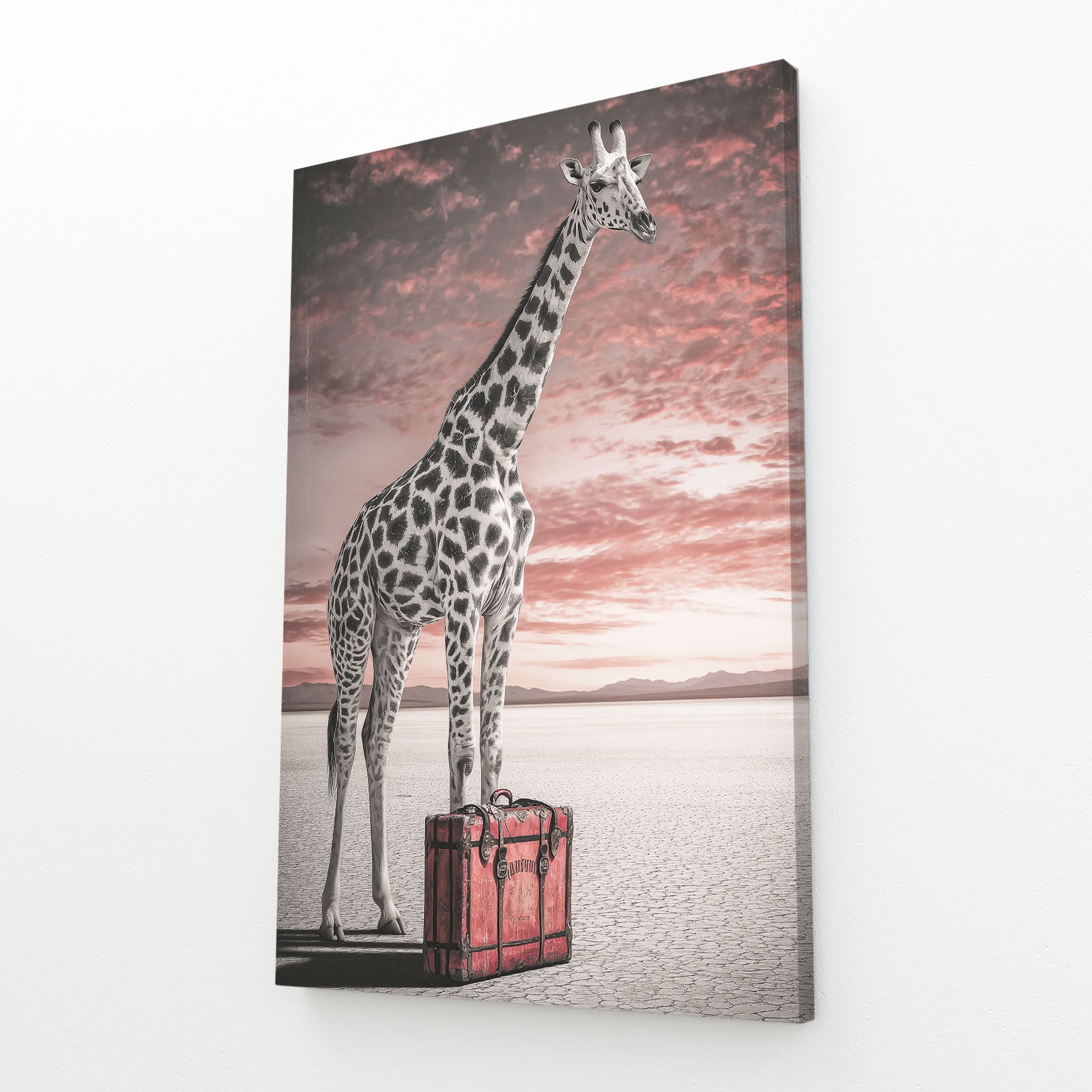 Canvas print of a giraffe standing on a suitcase with a sunset background